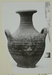 Two-handled pottery jar with a flared rim, photographed against a pale background