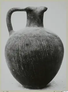 Jug with a single loop handle, tall neck and grooved globular body, recorded as Foreign Red Slip (C.M)