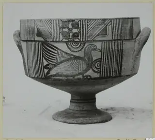 Painted pottery vessel with two small horizontal handles and a pedestal foot, decorated with stripes, circles and a bird.