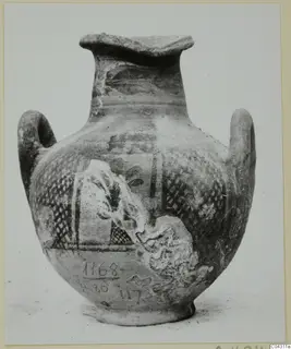 Two-handled painted pottery vessel with lattice-patterned bands and a framed panel, photographed against a pale background.