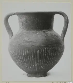 Two-handled vessel with vertical fluting on the lower body, labelled Foreign Red Slip