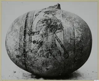 Globular jug with a painted human figure between vertical bands, photographed from the side.