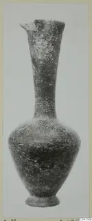Pottery vessel with a tall narrow neck, a flared rim with a pinched spout, and a ring foot