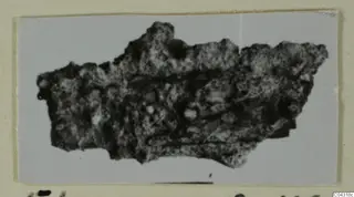 Corroded iron fragment from Amathus, shown as a photograph mounted on a card