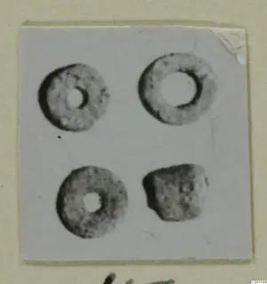 Four small ring-shaped objects from Amathus, photographed and mounted on a card.
