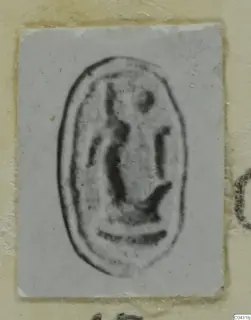 Oval seal impression on a small pale card, dark marks inside a raised border, from Amathus