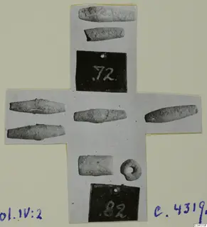 Cross-shaped card of photographs of slender tapered objects and a small ring with a hole, from Amathus tombs