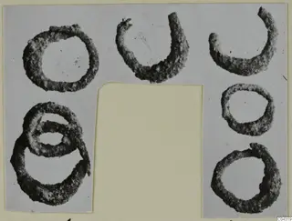 Corroded rings and loops from Amathus, one pair overlapping, shown together on a grey card mount