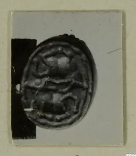 Oval seal with a raised design, from Amathus tomb group 2-26, photographed on a card mount