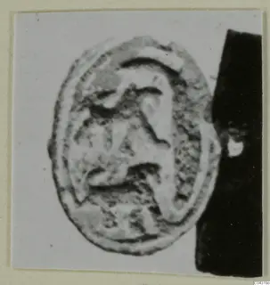 Oval engraved seal from Amathus, shown as a close-up photograph on a pale card background
