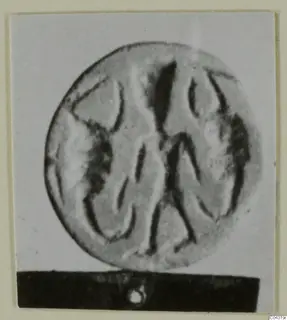Glyptic from Amathus: a round seal or gem with an incised design, shown on a dark stand