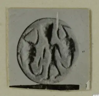 Engraved stone seal or gem from Amathus, photographed close up with raking light.