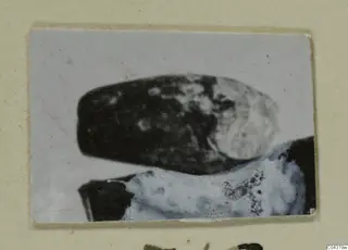 Two stone vessels from Amathus, one dark and one pale, in a close print mounted on a cream card
