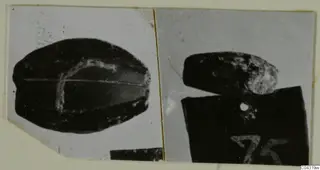 Two photographs of dark vessels from Amathus, one resting on a block with a handwritten number label