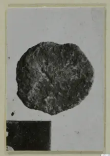 Corroded bronze object from Amathus, shown as a photographic print on a cream card mount