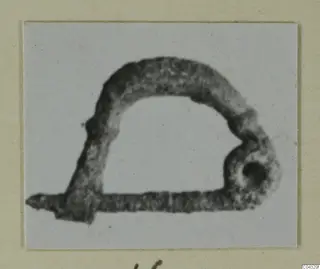 Corroded iron object from Amathus with an arched bar and a looped end