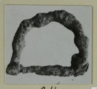 Dark, mottled ring-shaped find from Amathus, shown on a mounted card