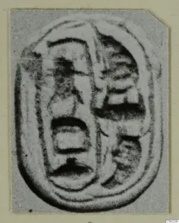 Oval engraved object from Amathus with incised signs and a raised outline, shown on a card mount
