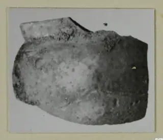 Broken faience fragment from Amathus with a flat projecting edge at upper left