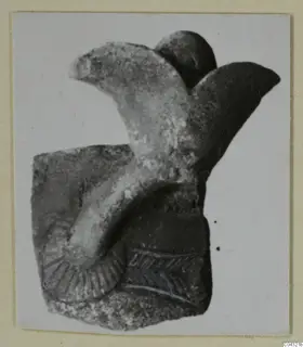 Faience fragment from Amathus: a curved raised element on a block-shaped base, with incised and blue-drawn marks.