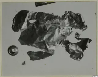 Crumpled gold jewellery fragments from Amathus, with a small hollow object at lower left.