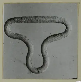 Bent rod-shaped object from Amathus, shaped into a looped, three-armed form