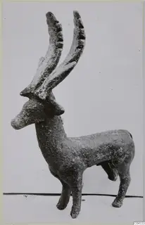 Bronze statuette of a standing stag with tall, curved antlers
