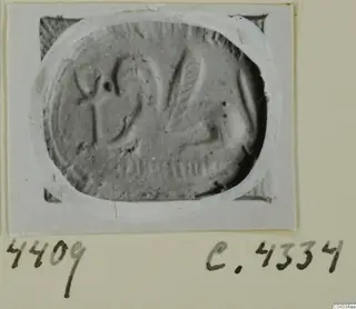 Engraved oval seal or gem from Ayia Irini, shown in a photograph on a card mount
