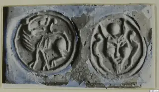 Two round engraved seal faces shown side by side, each with a raised figure design.