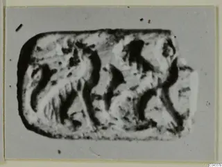 Engraved seal or gem, rounded rectangular in outline, with a carved design of curved and angular lines.