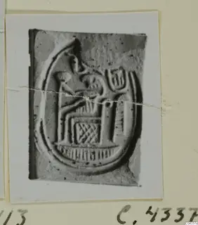 Stone seal from Ayia Irini with a seated figure and lattice pattern inside an oval border