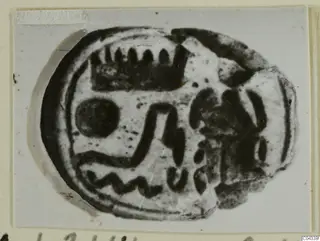 Oval seal from Ayia Irini with a dark engraved design on its flat base