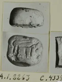 Two photographs of one small stone seal: its rounded side above and its carved face below, on a photo mount