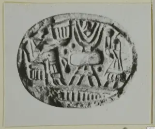Oval engraved seal or gem with linear and dotted motifs, photographed enlarged on a card mount