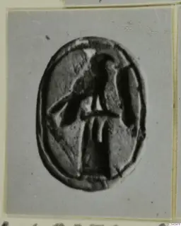Oval engraved seal or gem from Ayia Irini with a dark incised figure at its centre