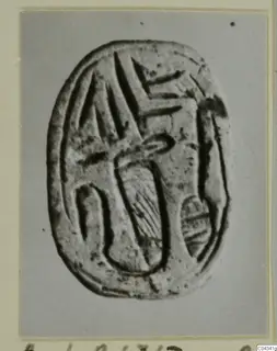 Oval seal with engraved signs on its flat face, photographed from Ayia Irini.
