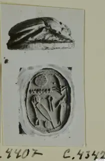 Scarab beetle and an oval seal face with carved figures, both photographed on a card mount