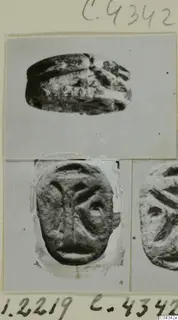 Stone seal shown in two views: domed back with ridged lines, and flat engraved base, mounted on a card with a partial second seal at right.