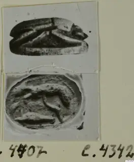 Scarab-shaped stone seal seen from the side, with its engraved oval base photographed below, mounted on a photo card