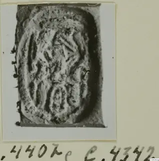 Engraved seal or gem from Ayia Irini, with incised curved and angular design, shown on an album card