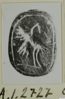 Engraved dark oval seal from Ayia Irini with a bird-like figure, photographed on a card mount