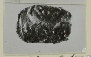 Oval stone seal or gem from Ayia Irini, dark with a rough, worn surface