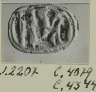 Glyptic object from Ayia Irini: an oval engraved seal or gem, photographed on a card mount