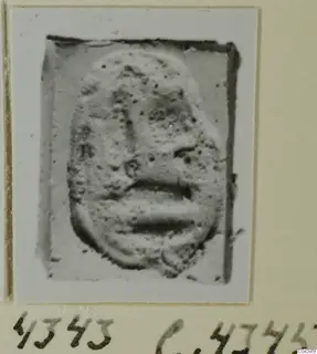 Stone glyptic object with a raised face in relief, from Ayia Irini