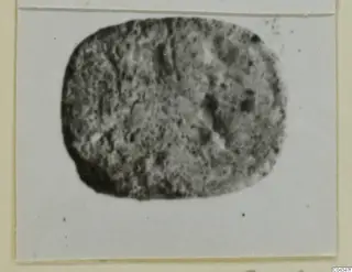 Oval stone glyptic from Ayia Irini, shown in a blurred photograph mounted on a card