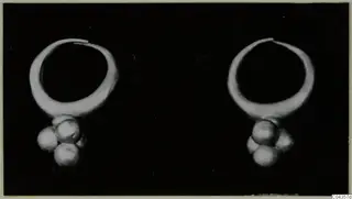 Two gold hoop rings, each with a cluster of small round pendants hanging below, from the Kastros tombs at Lapithos