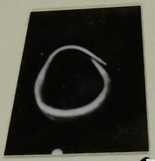 Gold ring-shaped object from the Kastros tombs at Lapithos, shown against a dark ground