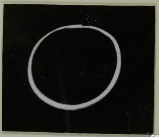 Gold ring shown as a bright oval outline on a black background
