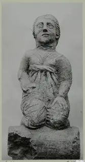 Stone statue of a kneeling figure from Soli, shown against a plain grey backdrop