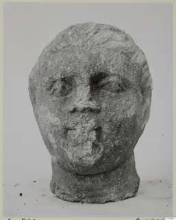 Stone head sculpture from Soli, shown front-on against a plain background.